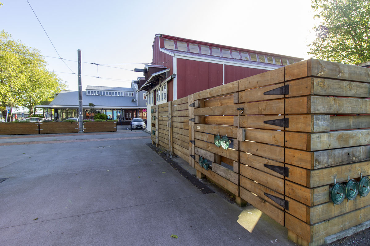 Rear corner of tram shed fence with view towards cafe.